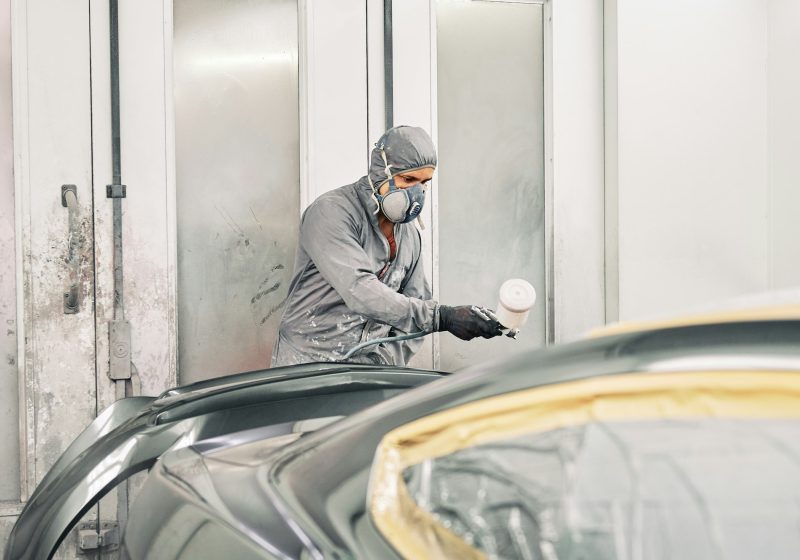 A man painting a car