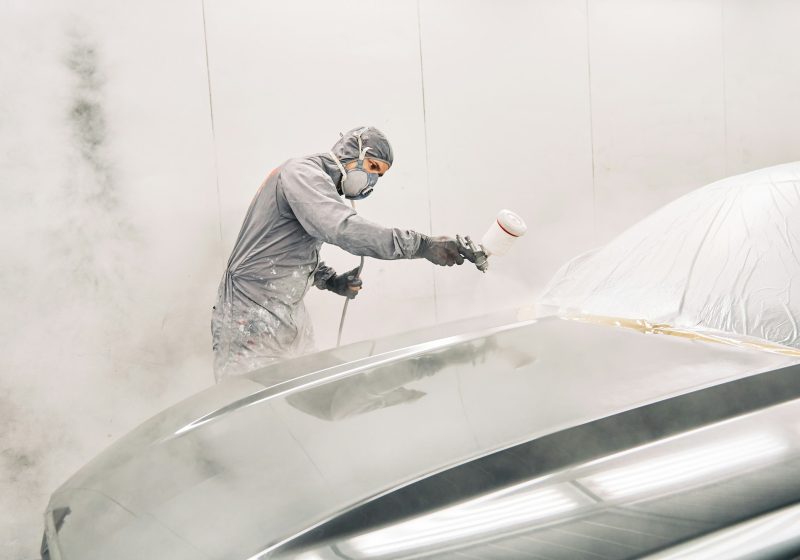 A man painting a car
